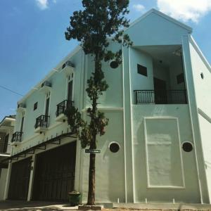 a building with a tree in front of it at ZG Homestay Solo in Sumber