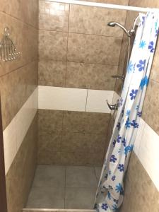 a shower in a bathroom with a shower curtain at Friendly House in Vyshneve
