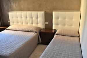 Postel nebo postele na pokoji v ubytování Camere Santa Chiara