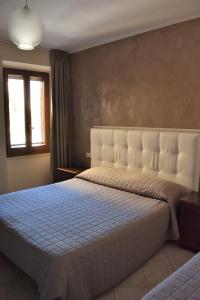Postel nebo postele na pokoji v ubytování Camere Santa Chiara