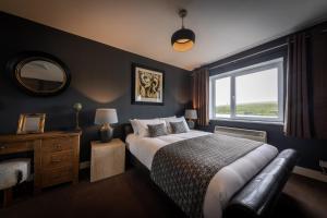 a bedroom with a large bed and a window at Storr Apartments in Portree