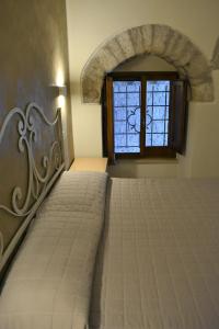 Postel nebo postele na pokoji v ubytování Camere Santa Chiara