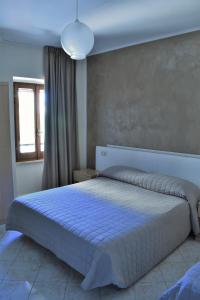 Postel nebo postele na pokoji v ubytování Camere Santa Chiara