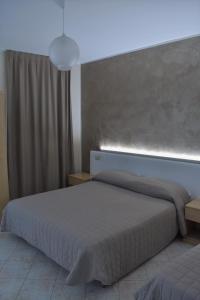 Postel nebo postele na pokoji v ubytování Camere Santa Chiara