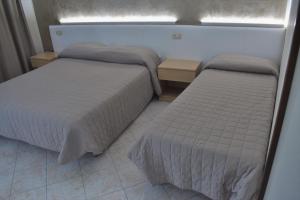 Postel nebo postele na pokoji v ubytování Camere Santa Chiara