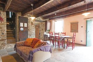 a cat laying on a couch in a living room at La Locanda Della Campanara in Galeata