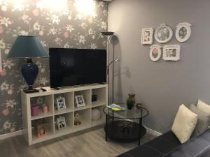 a living room with a tv and a couch at Prestige Apartment in Amarante