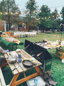 a picnic table with a grill in a park at Tobacco Village in Meinong