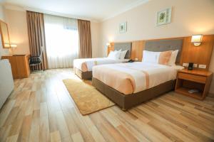 Postel nebo postele na pokoji v ubytování Mado Hotel