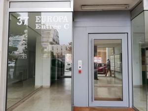 a door to a store with a sign on it at Le Sémaphore - studio climatisé, grande terrasse vue mer - parking, wifi in La Grande Motte