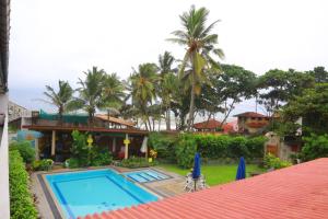 a view of a house with a swimming pool at Ranveli Beach Resort in Mount Lavinia