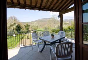a patio with a table and chairs on a balcony at Relais Il Ciliegio in Sorano