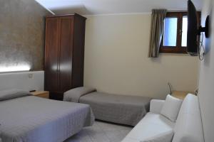 Postel nebo postele na pokoji v ubytování Camere Santa Chiara