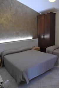 Postel nebo postele na pokoji v ubytování Camere Santa Chiara