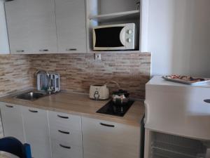 A kitchen or kitchenette at Ilaira Apartments Még 5 kép