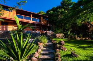 a house with a staircase leading up to it at Sunset Strip Eco Apartments in Florianópolis