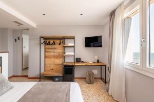 a bedroom with a desk and a window at Sea Tower Torre Telemetrica Lido di Venezia in Venice-Lido
