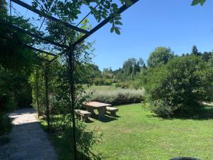 a picnic bench in a park with a field at Tenuta La Quassa in Ispra