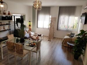 a living room with a table and a couch at Lolita's house Alhambra in Seville