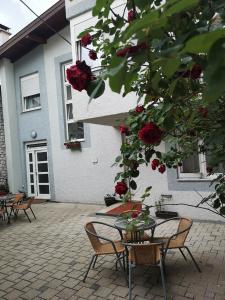 a patio with tables and chairs in front of a building at Elite Guest House in Mostar