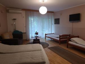 a living room with a couch and a chair and a tv at Elite Guest House in Mostar