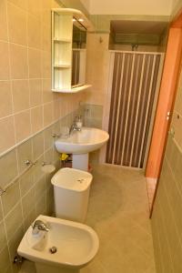 a bathroom with a toilet and a sink at Bilocali Civico16 in Porto Cesareo