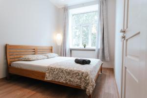 a bedroom with a bed and a window at Hanzas residence in Rīga