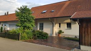 a house with a red roof and a driveway at Apartment Kern Lautrach in Lautrach