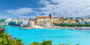 a view of a beach in a town with blue water at Podere San Luigi Residence in Otranto