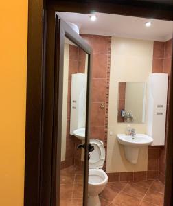 a bathroom with a toilet and a sink at Lux Studio Gabrovo in Gabrovo