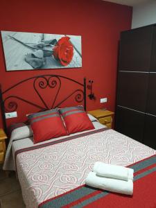 1 dormitorio rojo con 1 cama con paredes rojas en Casa Eva, en Arroyo Frío