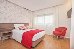 Postel nebo postele na pokoji v ubytování Essence Inn Marianos Hotel