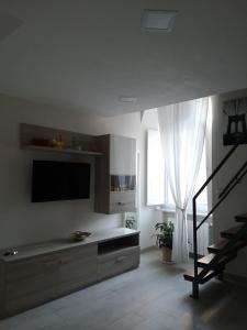 Una sala de estar con un televisor de pantalla plana en una pared. en CASA GIULIETTA, en Vico Equense