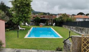 a swimming pool in the yard of a house at Casa dos Confrades in Arcos de Valdevez
