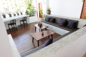 an overhead view of a living room with a couch and tables at The Sky Hometel in Koh Tao