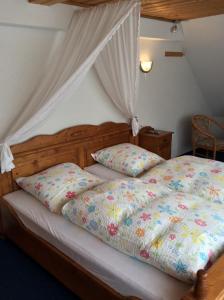 a bedroom with a bed with a canopy at Landhotel Quelle in Heidersdorf