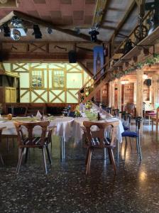 a dining room with tables and chairs in a building at Landhotel Quelle in Heidersdorf