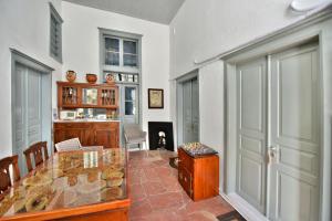 a dining room with a table and a door at Port Mansion Studio 2 Hydra - first floor not a hotel - no cl eaning while guests inside in Hydra