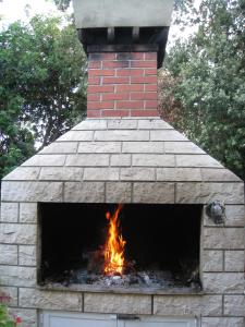 a brick oven with a fire in it at Villa Marin in Molunat