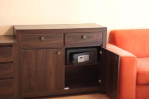 a cabinet with a tv and a couch in a room at Fortuna Lux apartments in Hévíz