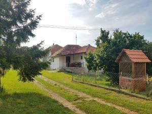 a house with a fence in front of a yard at Green Apartments in Kuršumlija