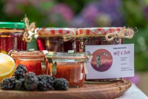 a group of jars of jam and blackberries on a table at Beeltjens B&B: Wolf&Belle in Westerlo
