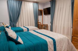 Posteľ alebo postele v izbe v ubytovaní Hostal Tribal