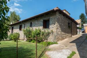 a stone house with a fence in front of it at O Zierzo in Jaca