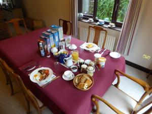 a purple table with breakfast food on it at At Last Bed & Breakfast in Edlington