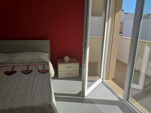 a bedroom with a bed and a glass wall at La Bussola in Porto Cesareo