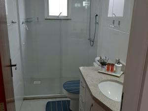 a bathroom with a shower and a toilet and a sink at Apartamento Santa Ana in São Joaquim