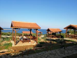 a group of gazebos with people sitting at a table at Siamese Villa in Paralimni