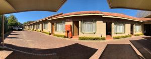 a building with a star on a brick road at Polokwane Lodge in Polokwane