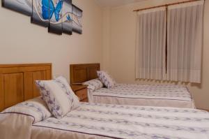 Posteľ alebo postele v izbe v ubytovaní Hostal Tribal